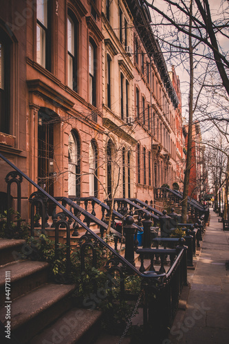Photography Row of old brownstone buildings along an empty sidewalk block in the Greenwich V