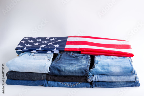 Jeans stack on a white background in store and supermarke and flag USA .t.concept fashion dress jeans..