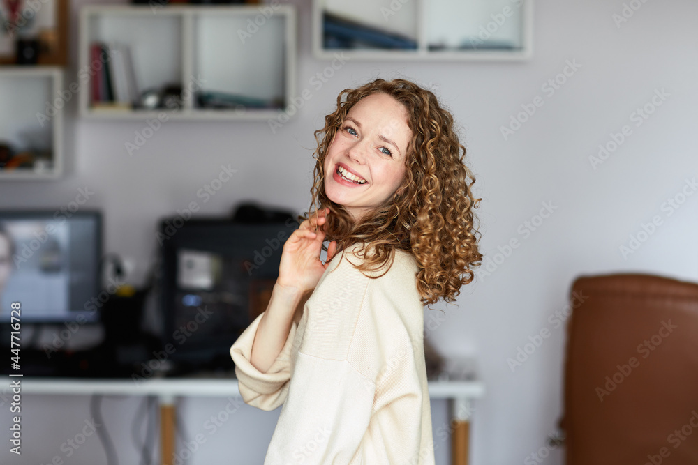 Picture of young smiling beautiful positive ginger woman indoors at home take selfie by camera. Picture of young smiling beautiful positive ginger woman indoors at home take selfie by camera.
