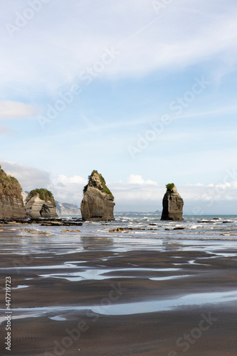 Travel lifestyle view of Three Sisters rock formations on Tongaporutu beach in northern Taranaki, on the North Island of New Zealand. photo