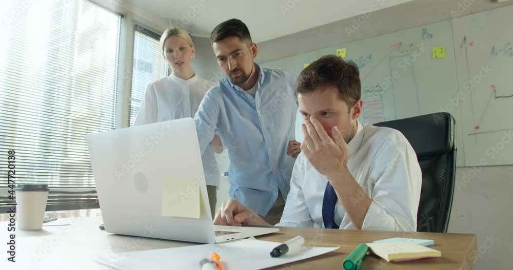 Stressed shocked diverse workers office team frustrated about business failure reading bad news results or email looking at laptop, depressed upset colleagues having problem Stressed shocked diverse workers office team frustrated about business failure reading bad news results or email looking at laptop, depressed upset colleagues having problem