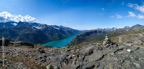 Wide panorama of the tourist trail among the rocks, hills and mountains under the blue sky. Besseggen Ridge in Jotunheimen National Park, Norway