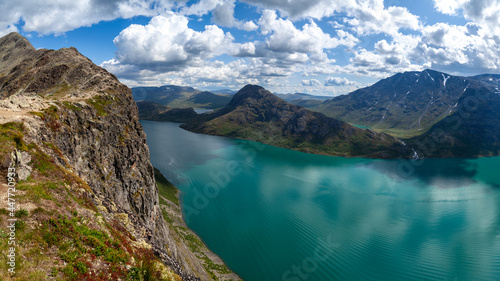 Besseggen weg inNational Park  Norway. View from the cliff of the picturesque panorama of the mountains on the horizon and on waters of Gjende Lake under blue skies. 