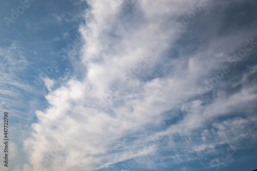 Blue sky background with big white tiny stratus cirrus striped clouds