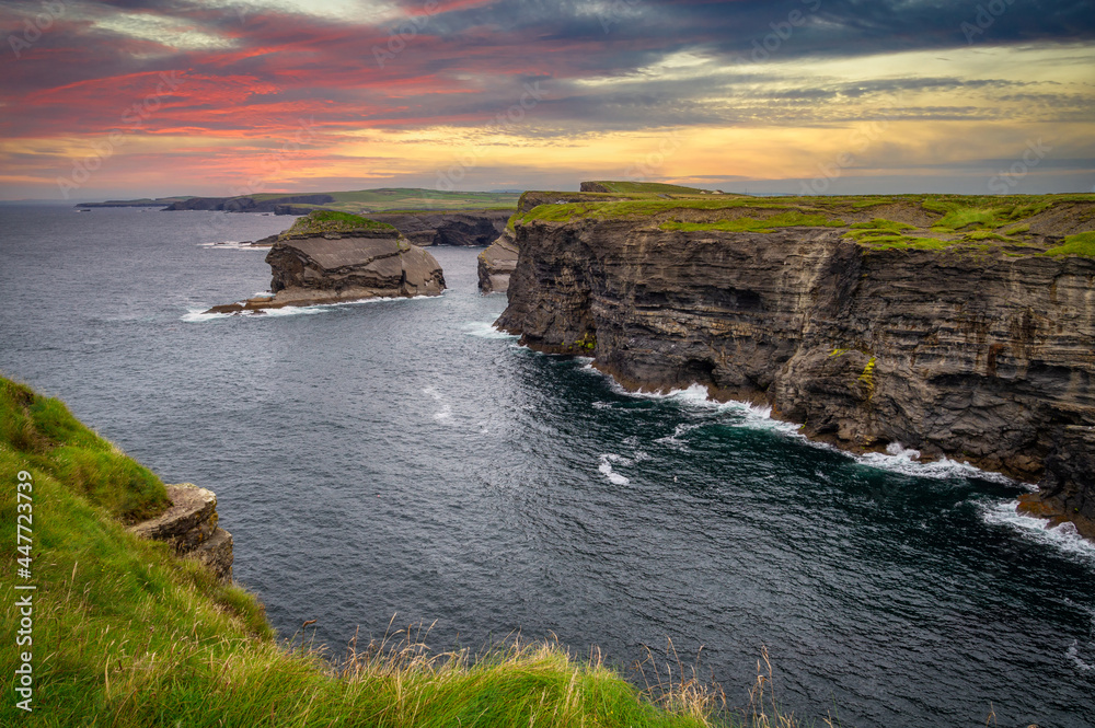 Rocky cliffs in Kilkee at sunset, County Clare. Ireland.