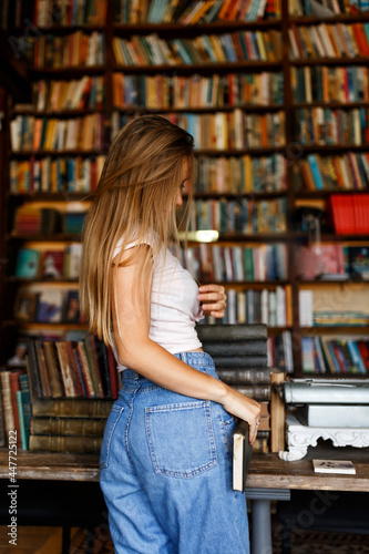 Beautiful female student or teenager in a university library or bookstore