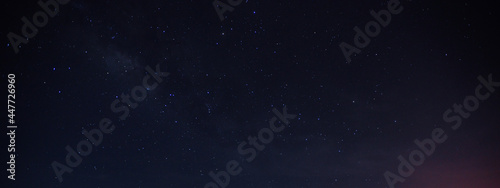 Fototapeta Naklejka Na Ścianę i Meble -  Panorama blue night sky milky way and star on dark background. Universe filled with stars, nebula and galaxy with noise . select white balance and selection focus.