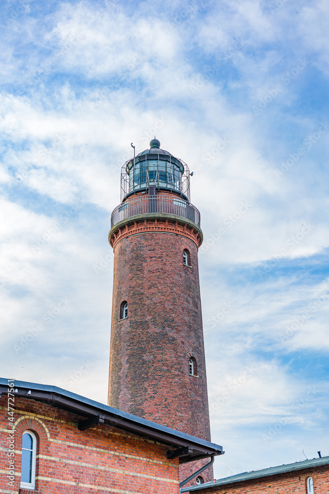 View from the beach to the Darsser Ort lighthouse on the German Baltic Sea coast. View from the beach to the Darsser Ort lighthouse on the German Baltic Sea coast.