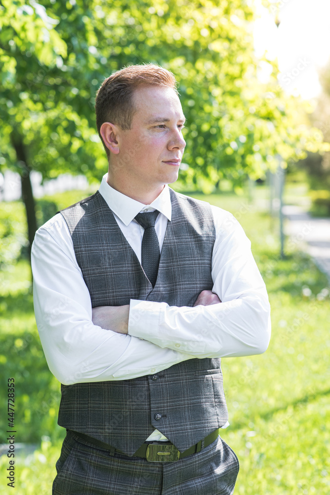 Portrait of redhead male businessman with crossed arms on nature Portrait of redhead male businessman with crossed arms on nature