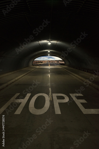 Word hope written on a road with light at the end of a tunnel, USA photo