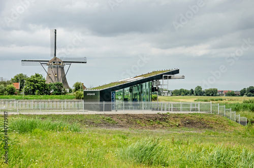 Lansingerland, The Netherlands, July 27, 2021: windmill De Valk and the modern pumping station that has taken over the dask of draining the adjacent polder photo
