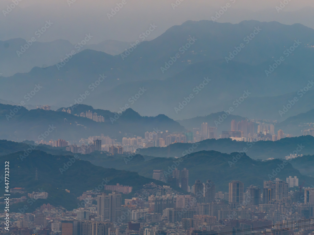 Morning sunrise high angle view of the mountains and cityscape around Wuzhi Shan