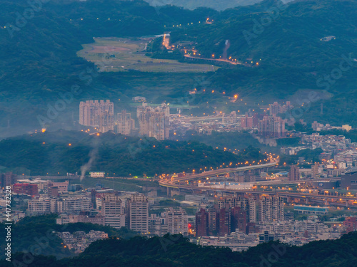Morning sunrise high angle view of the mountains and cityscape around Wuzhi Shan