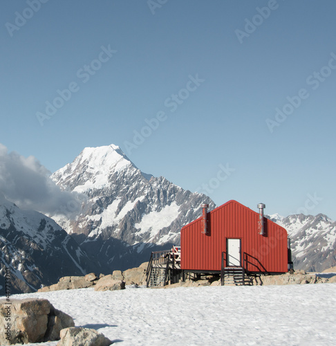 Travel lifestyle view of snowy red mountain hut Mueller Hut under Mount cook mountain in winter, in Aoraki / Mount Cook National Park, South Island of New Zealand.