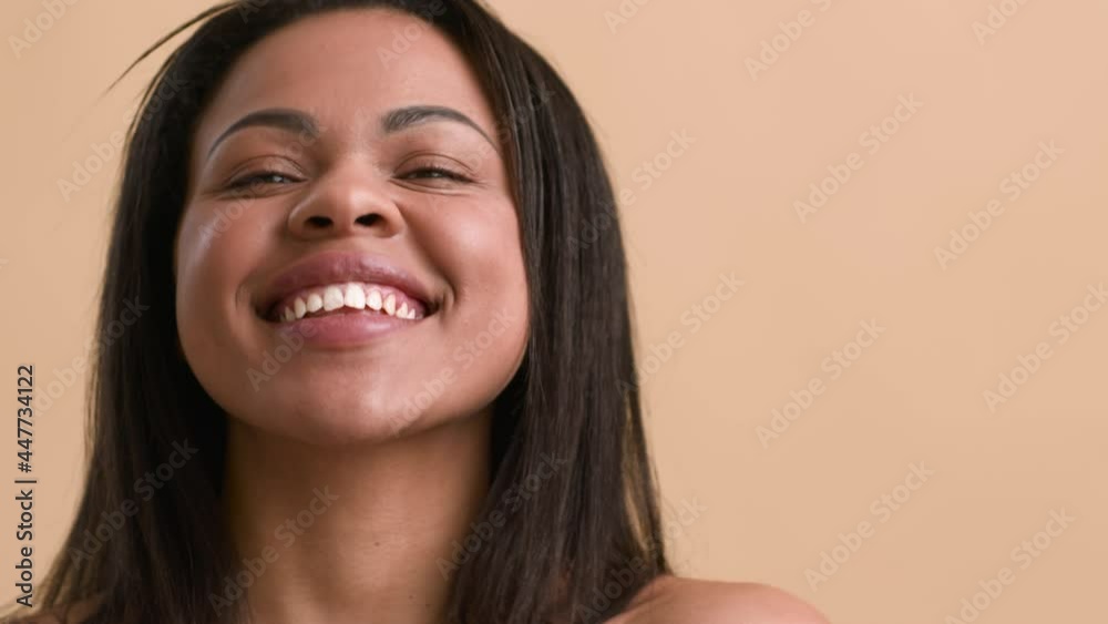 Black Woman Posing Smiling And Sticking Out Tongue, Beige Background