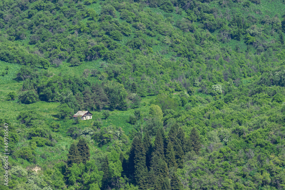 View of the old house on a slope in the mountains