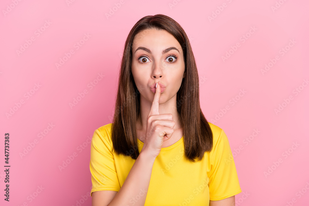 Photo of funny confident young woman dressed yellow t-shirt finger mouth asking keep silence isolated pink color background Photo of funny confident young woman dressed yellow t-shirt finger mouth asking keep silence isolated pink color background