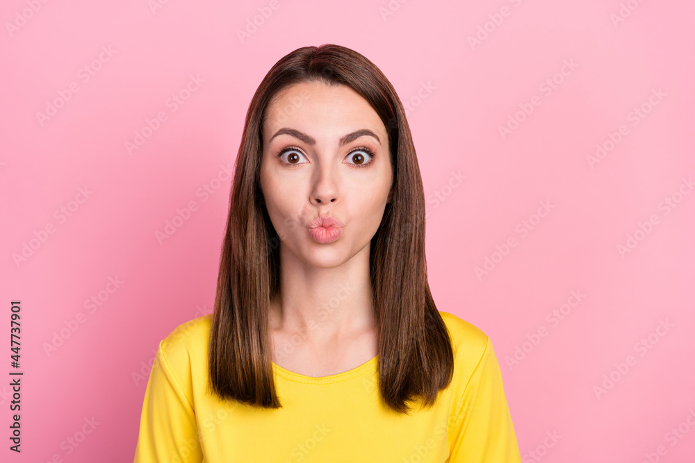 Photo of flirty brunette hair millennial lady blow kiss wear yellow t-shirt isolated on pastel pink color background Photo of flirty brunette hair millennial lady blow kiss wear yellow t-shirt isolated on pastel pink color background