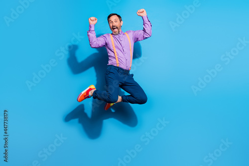 Full body photo of mature man happy positive smile jump rejoice victory success isolated over blue color background