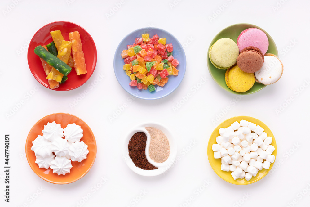 Candied fruits and macaroon in colorful plate at white background Candied fruits and macaroon in colorful plate at white background