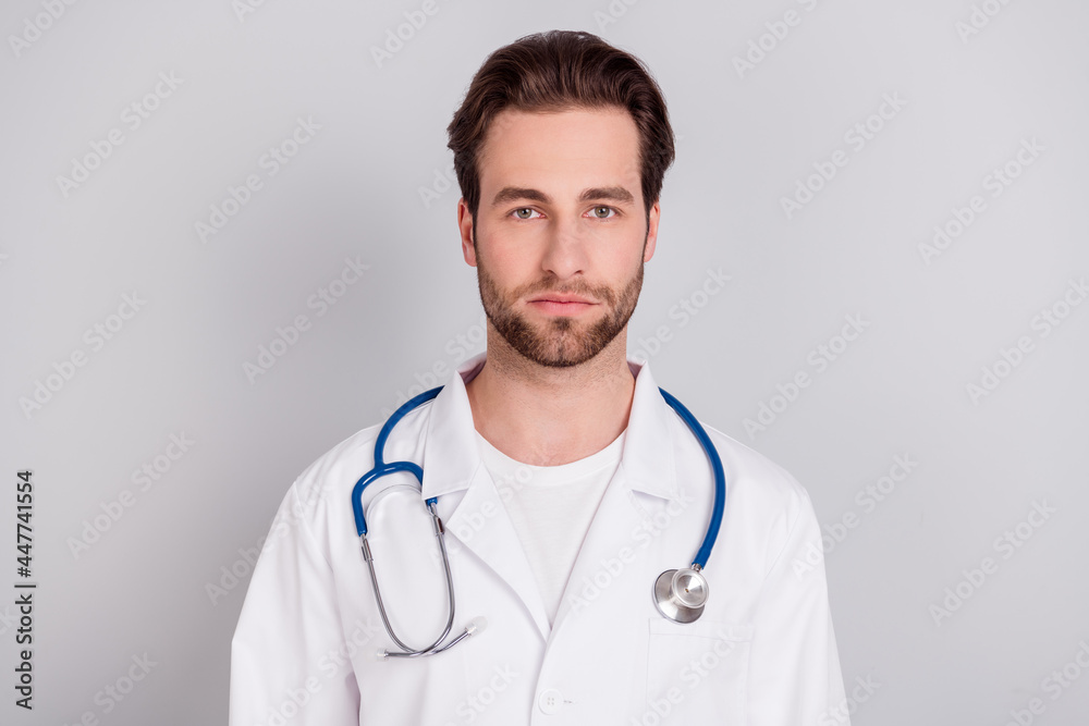 Photo of confident pretty young guy doctor workwear standing looking you isolated grey color background Photo of confident pretty young guy doctor workwear standing looking you isolated grey color background