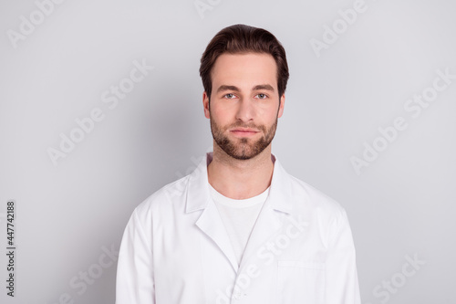 Photo of attractive confident young guy doctor workwear isolated grey color background © deagreez
