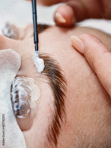 Cosmetician doing eyebrow lamination procedure