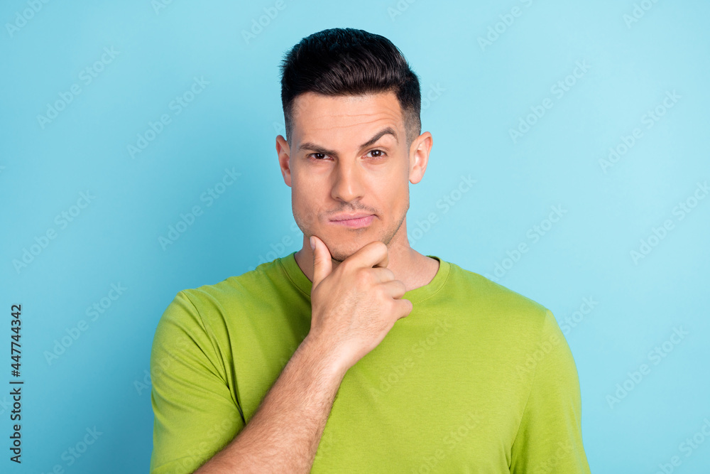 Photo portrait man in green t-shirt thoughtful got idea isolated pastel blue color background