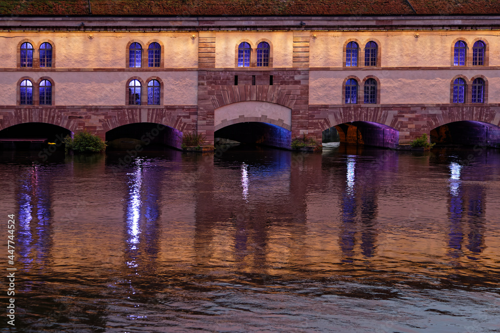 STRASBOURG, FRANCE, June 23, 2021 : Barrage Vauban at night. This bridge, weir and defensive work was erected in the 17th century on the Ill river, and named Great Lock.