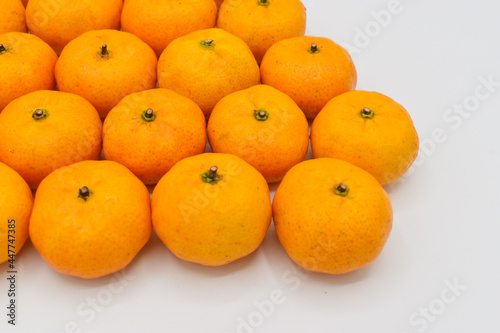 Mandarin oranges in stacks. Isolated on white.