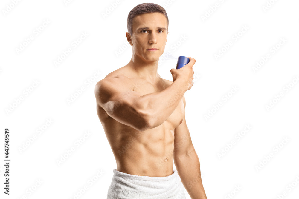 Fototapeta premium Shirtless young man spraying a perfume