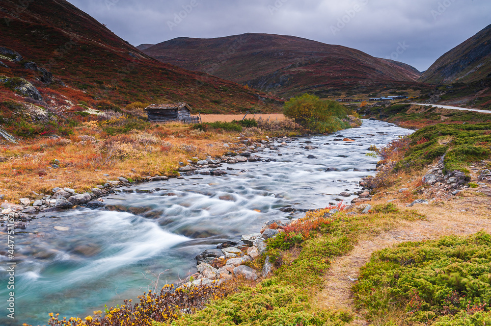 Flowing water in autumn colored mountain landscape Flowing water in autumn colored mountain landscape