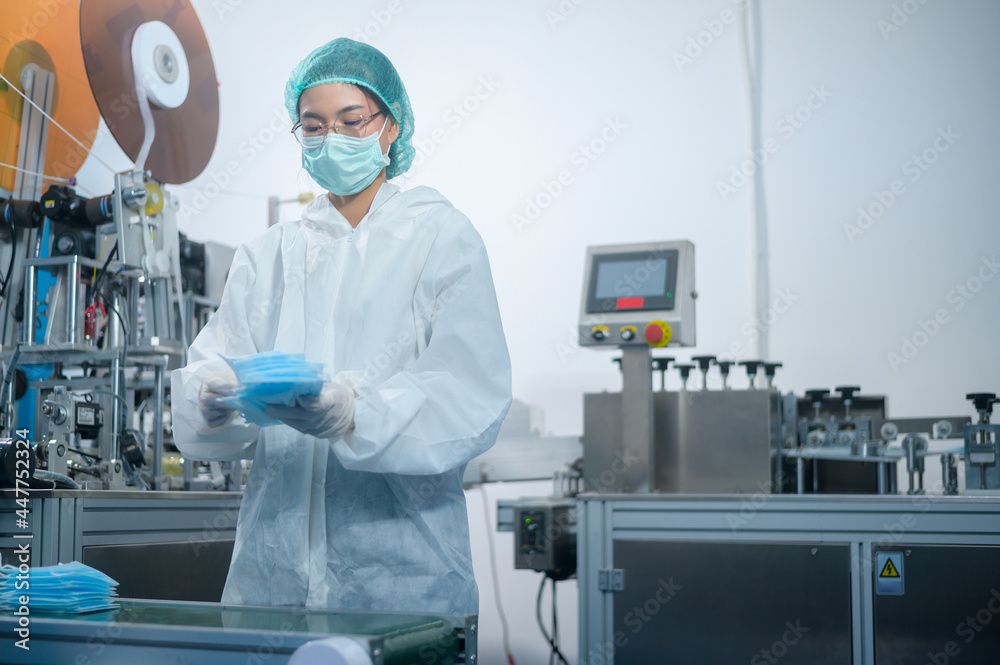 Workers producing surgical mask in modern factory, Covid-19 protection and medical concept. Workers producing surgical mask in modern factory, Covid-19 protection and medical concept.