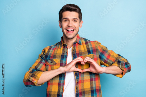 Portrait of attractive cheerful glad amazed guy showing heart sign health care medicine isolated over bright blue color background