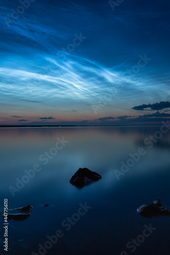 Night shining clouds (noctilucent clouds) over lake "Vänern" in Sweden.