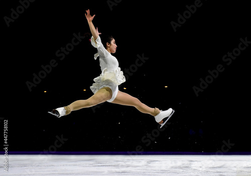 Mid air split jump performed by a professional ice skater