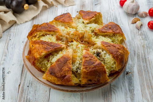 фотографія shah pilaf on plate on white wooden table