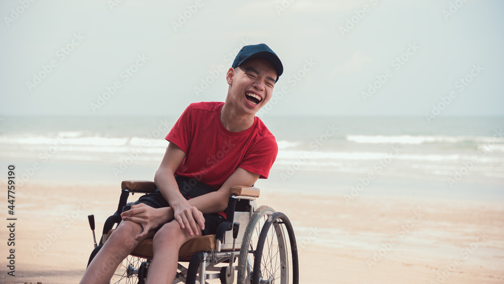 Asian happy disabled teenage boy, Activity outdoors with family on the beach background, People having fun and diverse people concept. Asian happy disabled teenage boy, Activity outdoors with family on the beach background, People having fun and diverse people concept.