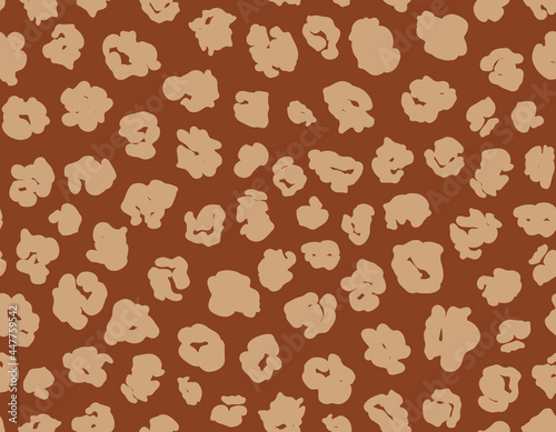 Abstract leo seamless repeat pattern. Random placed, animal skin vector spots all over surface print on brown background.