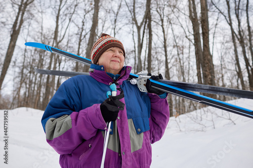 Portrait of a senior skier in a winter forest