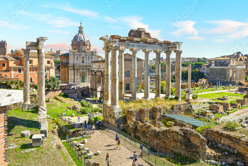 The ancient Roman Forum on sunny summer day as tourists walk the paths. View facing northeast from above the Portico Dii Consentes