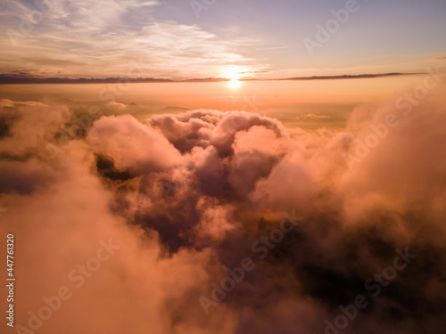Aerial view of sunset above clouds in Schwyz, Switzerland photo
