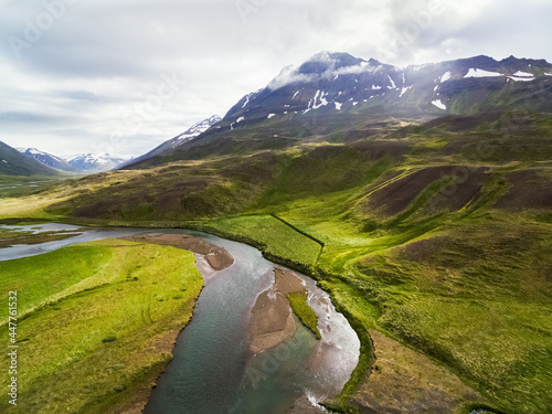 Aerial view of stream and grassland in front of a mountain, Oxnadalur, Iceland photo