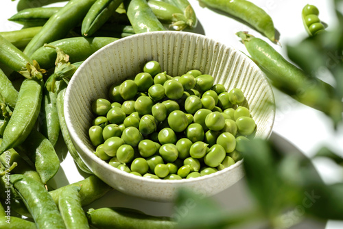 green peas and pods on a white background