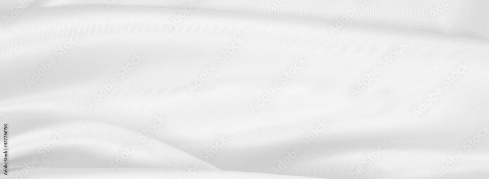 Smooth elegant white silk or satin luxury cloth texture as wedding background. Luxurious background design