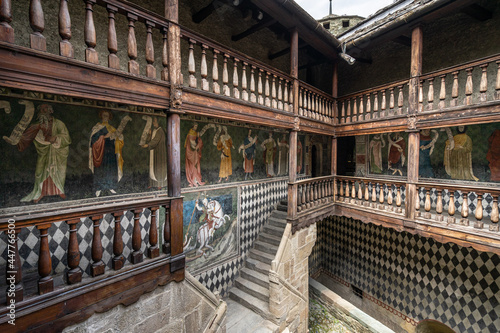 Inner courtyard of Fenis Castle with medieval frescoes decorating the walls, Aosta Valley, Italy