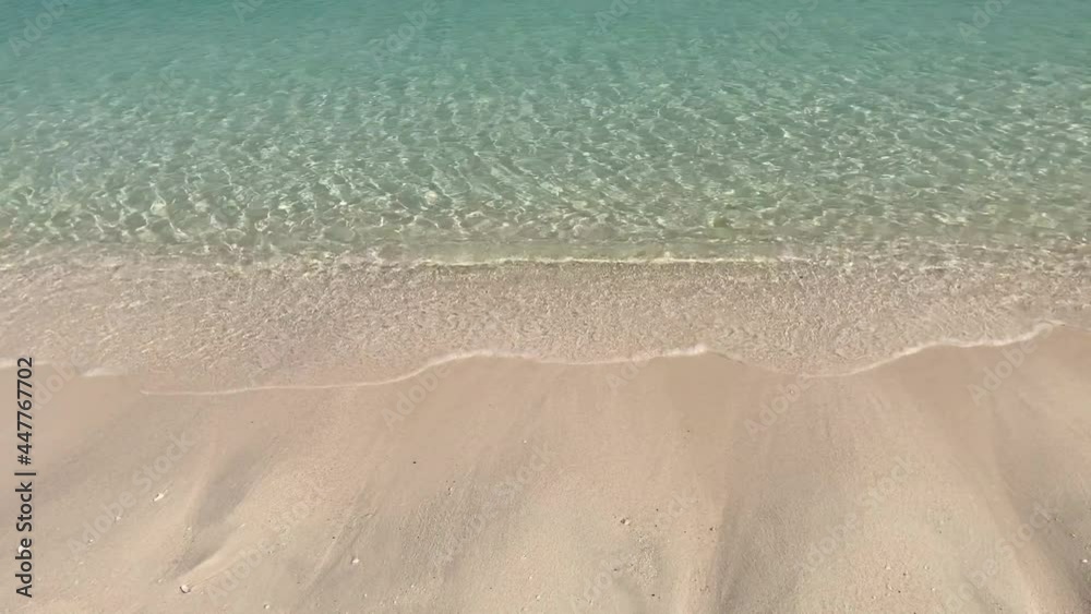 Aerial top view of ocean blue waves break on a beach. Sea waves and beautiful sand beach aerial view drone shot. Bird's eye view of ocean waves crashing against an empty sand beach from above. Aerial top view of ocean blue waves break on a beach. Sea waves and beautiful sand beach aerial view drone shot. Bird's eye view of ocean waves crashing against an empty sand beach from above.