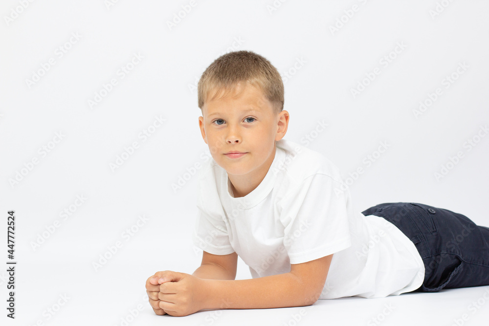 Little boy laying relaxed on white floor at home
