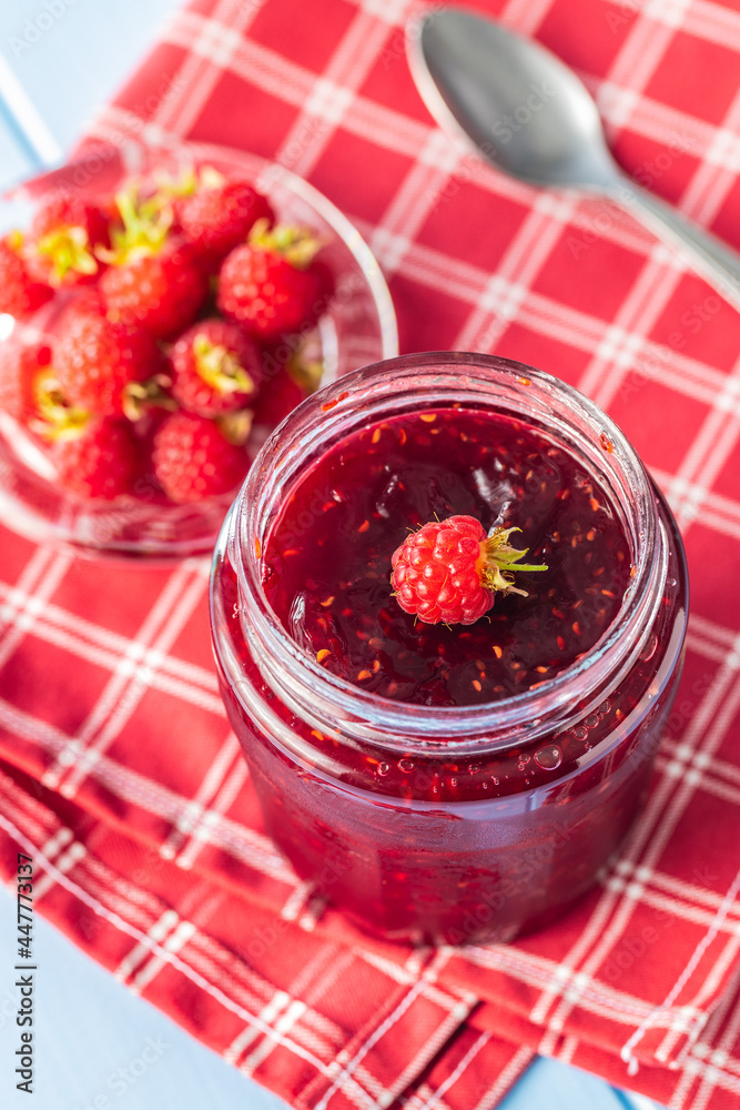 Red rasberries jam in jar and ripe raspberries. Red rasberries jam in jar and ripe raspberries.
