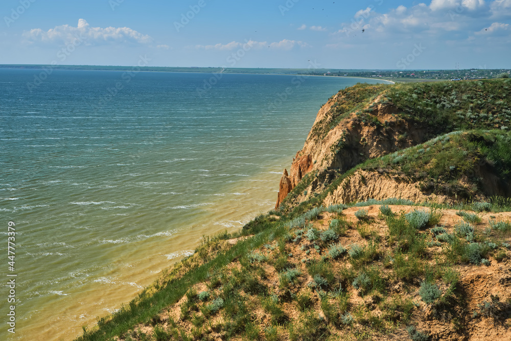 Beautiful landscape, sandy cliff over the sea.